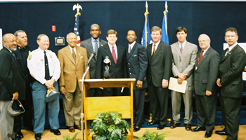 Photo (Left to Right): Chief William F. Corvello, Portsmouth PD; Chief Richard Justice, Chesapeake,PD; Dr. James W. Holley III, Portsmouth, VA. Mayor; RC Gamble, Special Agent-in-Charge, DEA Washington Division Office; Paul McNaulty, United States Attorney, Eastern District of Virginia; Pastor & Co-Founder of Vision I Center, Portsmouth, VA.; Michael Varnum, Special Agent-in-Charge, Federal Bureau of Investigation, Norfolk Office; Frank Shults, Assistant United States Attorney; C.W. McCoy, City Manager, Por