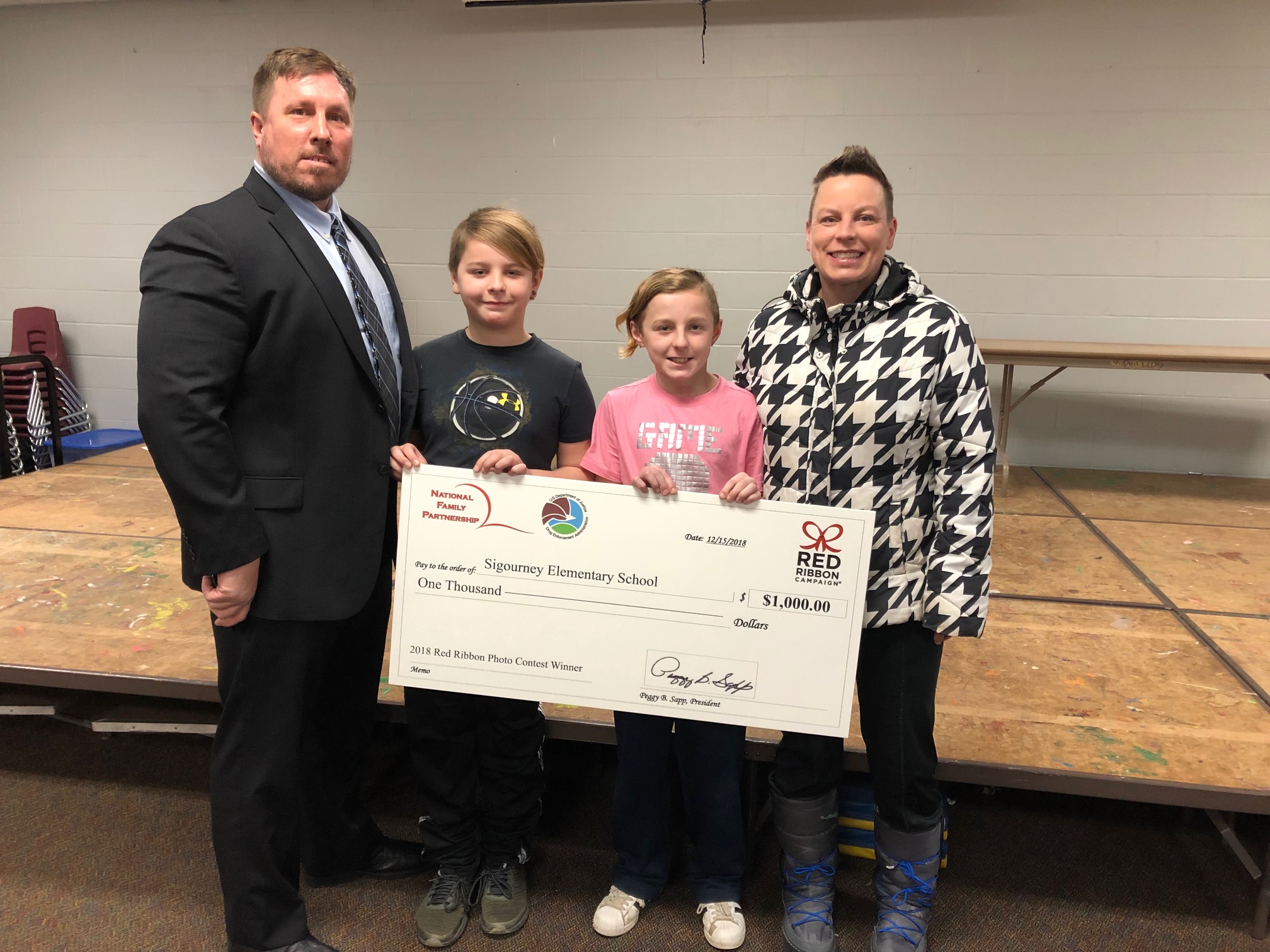 The Des Moines Resident Agent in Charge, along with Owen, Wells and their mother, Megan Clarke.