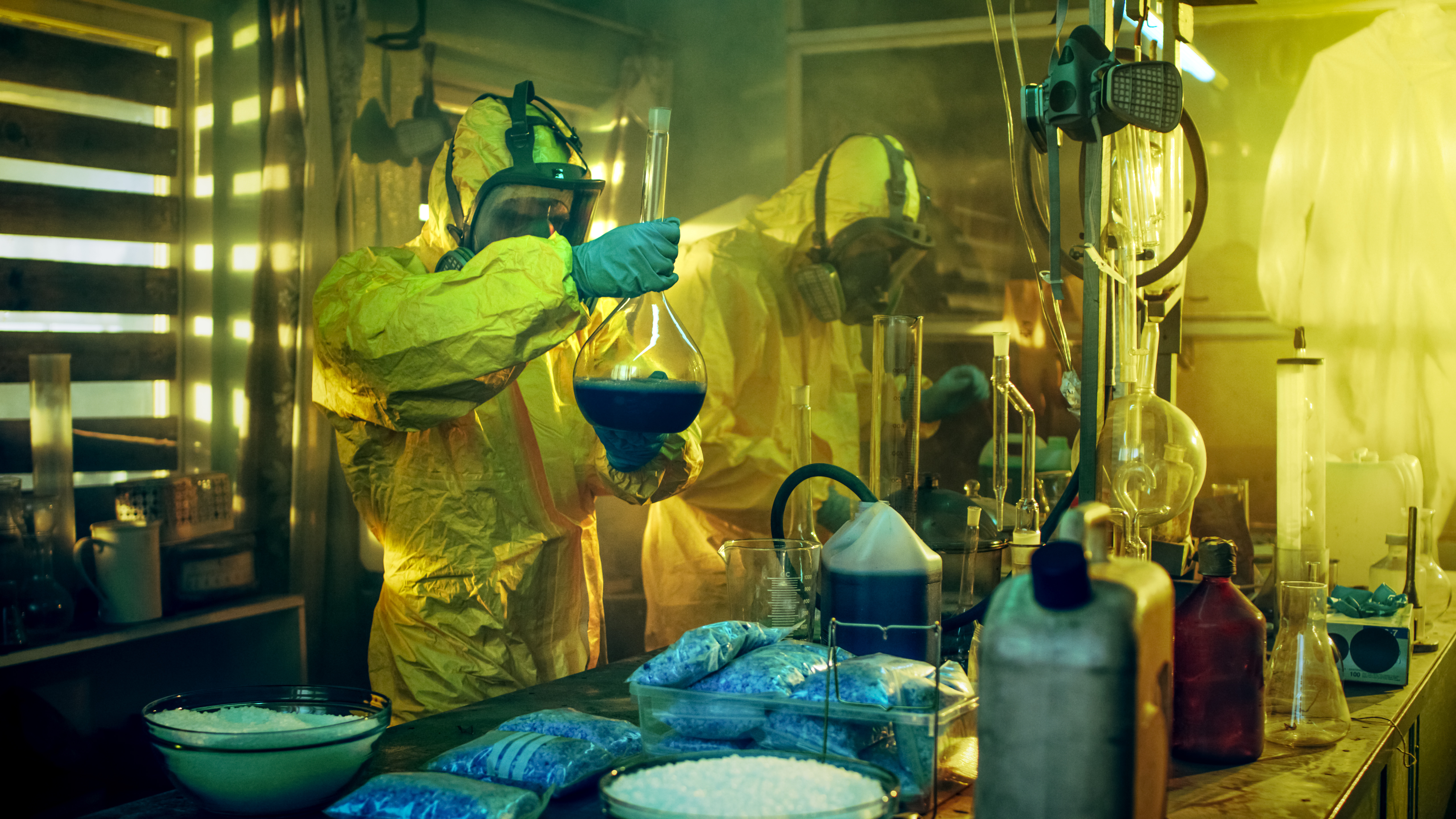 men wearing hazmat suits in a meth lab