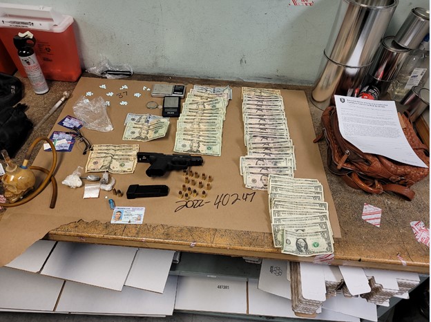 Seized firearm, fentanyl, cash.