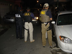 DEA and FBI special agents provide perimeter security at an arrest location.