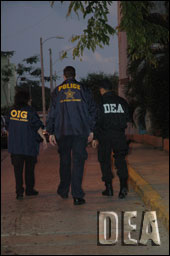 (L-R) Health & Human Services OIG, U.S. Secret Service and DEA agents execute arrest warrants at one of the public housing projects.