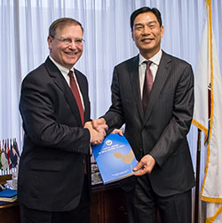 People's Republic of China Narcotics Control Bureau Director General Hu Minglang presents DEA Acting Administrator Chuck Rosenberg with his government's 