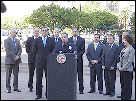 LAPD Commander Sergio Diaz speaks with the media as LA HIDTA Associate SAC Briane Grey (fourth from right) and Assistant SAC Jon Goldberg (third from right) look on.