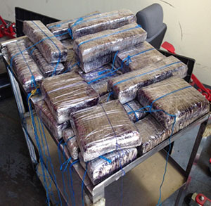 Over 30 pounds of heroin hidden in a Honda and discovered by the canine unit.