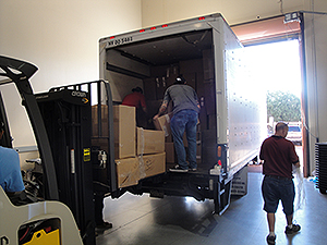 Personnel load a semi-truck with collected prescription drugs from DEA’s National Prescription Drug Take Back Day.