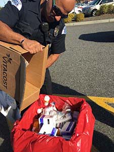 Pasco, Washington law enforcement officer disposing of prescription medicines at Take Back Saturday, October 22, 2016