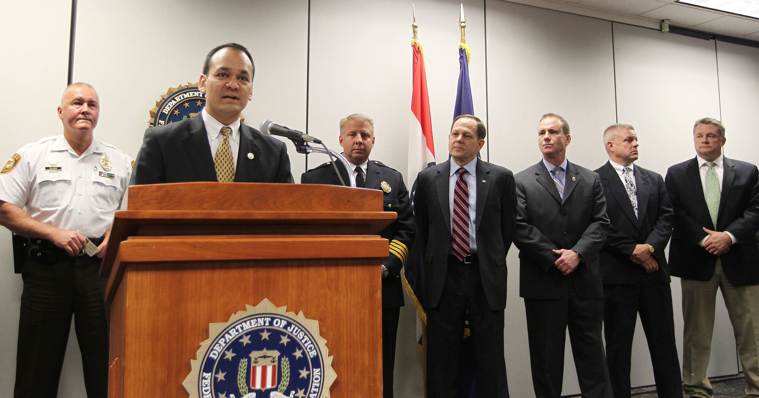 St. Louis County Police Chief Jon Belmar, FBI SAC William Woods,  St. Louis Metropolitan Police Chief Sam Dotson, Mayor Francis Slay, SAC James Shroba, St. Louis County Prosecutor Tom Dittmeier, and St. Louis County Criminal Investigator Chris Nappier