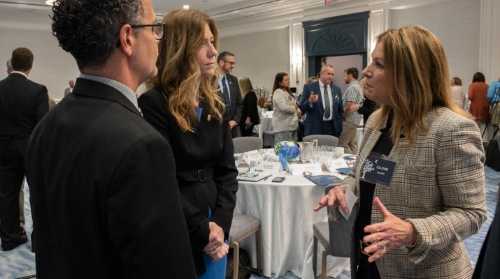 Mrs. Milgram and Jon DeLena meeting with participants