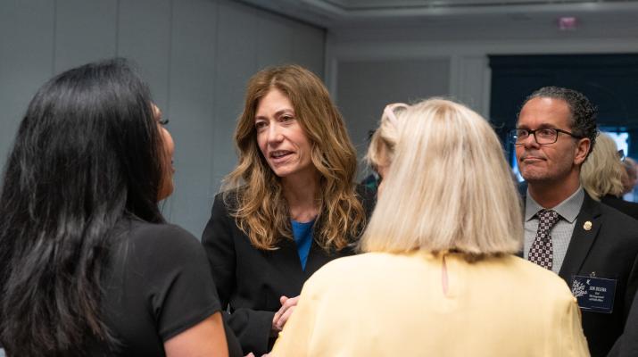 Mrs. Milgram and Jon DeLena meeting with participants