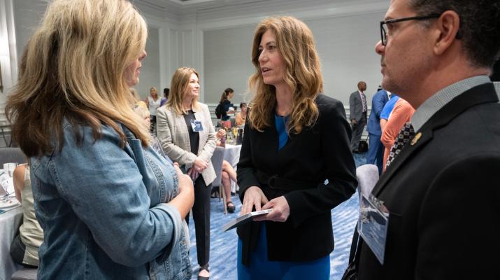 Mrs. Milgram and Jon DeLena meeting with family member