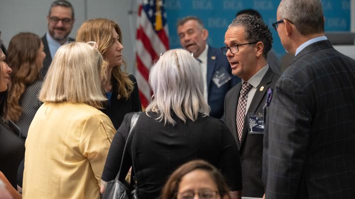 Mrs. Milgram and Jon DeLena meeting with family members