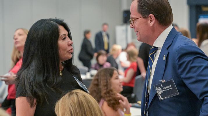 Principal Deputy Administrator Louis J. Milione speaking with family members