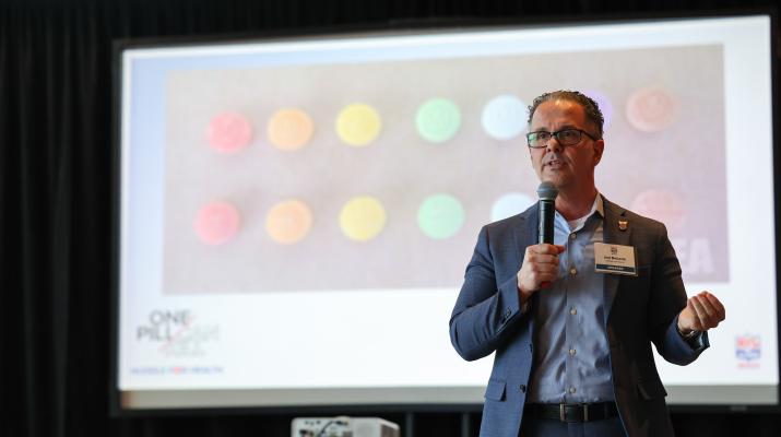 Jon DeLena speaking at the NFL Alumni Health Symposium