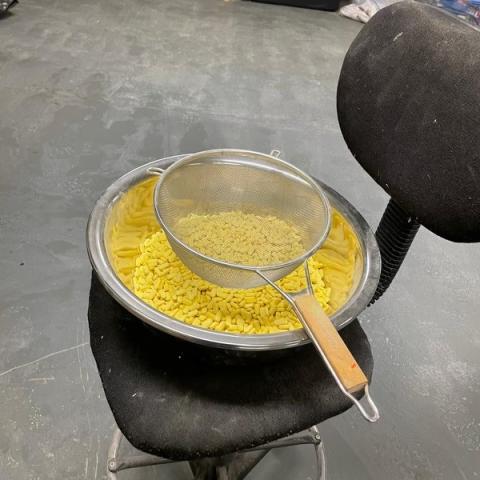 Large bowl of yellow pills