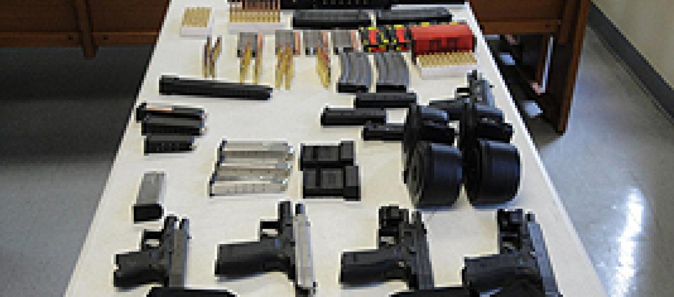 Automatic weapons , magazines, ammunition possessed by convicted felons Julio Pastrana and Alexander Ortiz. They face charges of firearms possession while being convicted felons.