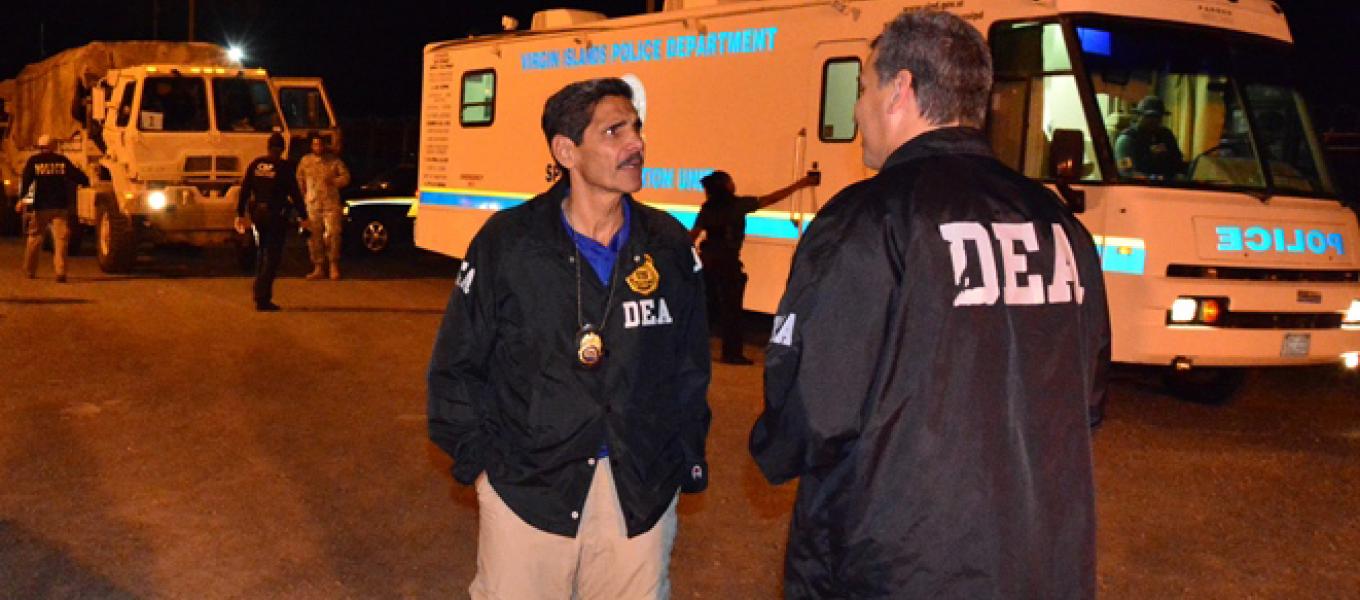 DEA Caribbean Division Special Agent in Charge Vito Salvatore Guarino (center), talking to one of his agents, leads the search warrant operation.