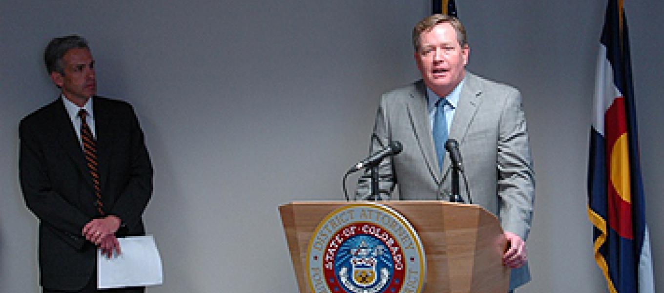 Acting Special Agent in Charge Kevin R. Merrill at the podium, and U.S. Attorney for the District of Colorado John F. Walsh.